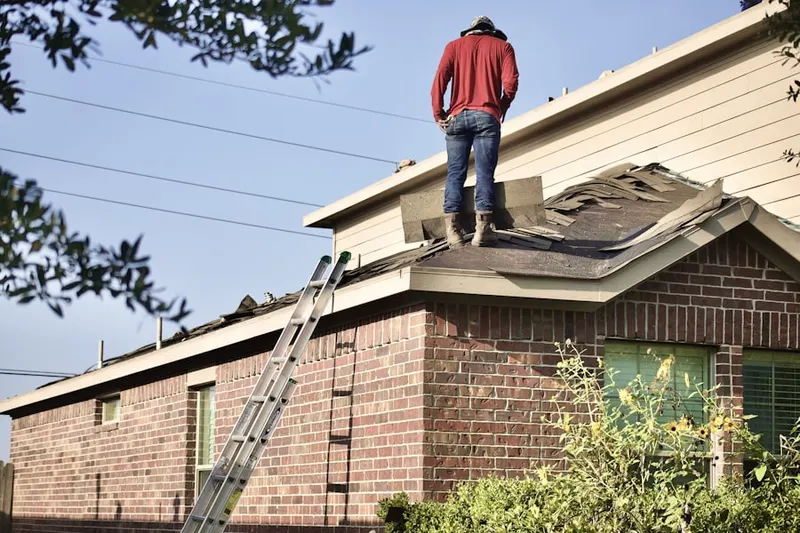 Professional roofer working on a residential roof in Martins Beach